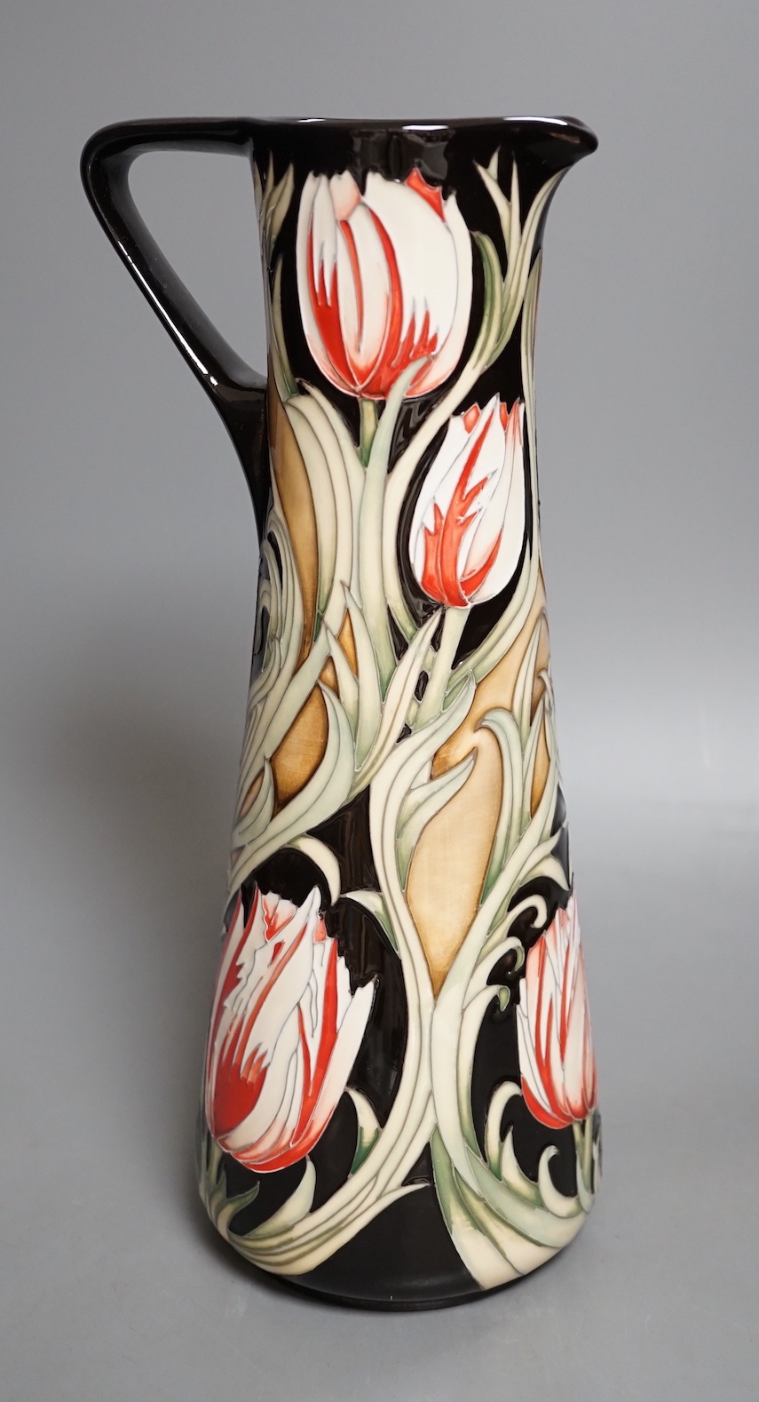 A Moorcroft 'race against time' jug by Paul Hilditch, limited edition 11/40, boxed, 31 cms high.